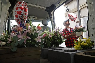 James Branam loads up a delivery van with Mother's Day flower orders from Fairy Tale Floral ahead of the holiday weekend Friday, May 12, 2023. (Arkansas Democrat-Gazette/Colin Murphey)